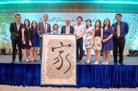 Alumni’s farewell gift is a large fabric handwritten with a large “Home” in Chinese character, surrounded by 560 alumni’s English names.